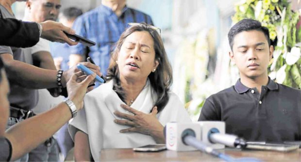 FAMILY’S GRIEF Gertrudes Duran-Batocabe, widow of slain Ako Bicol Rep. Rodel Batocabe, and their son Justin are interviewed by reporters on the Bicol University Daraga campus in Albay.