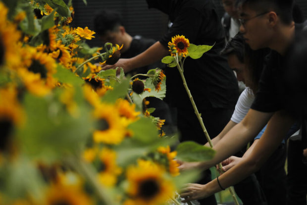 Parents of Hong Kong protester who died urge others to live
