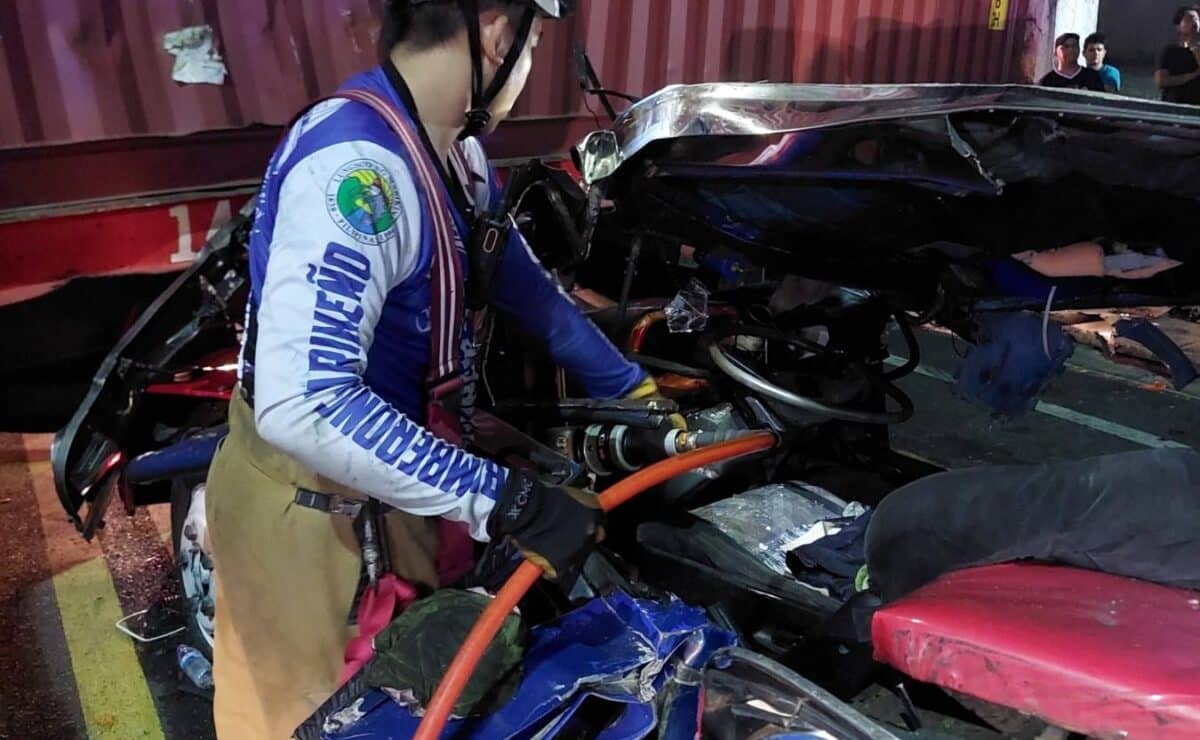 A firefighter works to rescue the occupants of one of five vehicles crushed by a trailer truck in an accident along Fortune Avenue in Marikina City on Wednesday night. — Photo from the Marikina Filipino-Chinese Fire Brigade Volunteers